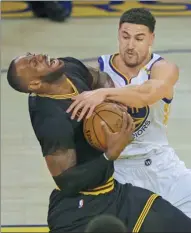  ?? BEN MARGOT / AP ?? Cleveland Cavaliers’ LeBron James is fouled by Klay Thompson of the Golden State Warriors during the second quarter of last Sunday’s Game 2 of the NBA Finals in Oakland, California. Game 3 is on Wednesday night in Cleveland, with the Warriors leading...