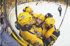  ?? Bruce Bennett / Getty Images ?? The Predators’ James Neal (18) celebrates with teammates after his second-period goal against the Penguins to help keep Nashville’s hopes alive in the series.