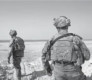  ?? MAYA ALLERUZZO/AP ?? U.S. soldiers survey the safe zone between Syria and the Turkish border in September near Tal Abyad, Syria.