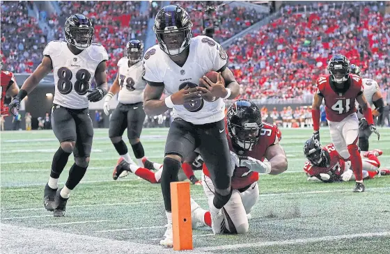  ??  ?? Ravens quarterbac­k Lamar Jackson, No.8, runs for a touchdown against the Falcons.