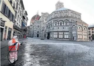  ?? CARLO BRESSAN AFP/GETTY IMAGES ?? A municipal employee disinfects the Piazza Santa Croce in front of Basilica Santa Croce in Florence on Saturday. The tragedy of Italy now stands as a warning to other countries.