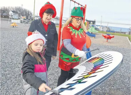  ?? SHARON MONTGOMERY-DUPE • CAPE BRETON POST ?? Cathy Macintyre, left, former long-time chair of the Marica Fiolek Memorial Playground in Dominion, and Janine Fiolek, mother of the late Marcia Fiolek who the playground is named after, watch as Macintyre's granddaugh­ter Rylee Macneil, 5, plays the xylophone at the park during a visit this week. The playground was a vision of Marcia's, who died in 1996 at age 10 and had been selling suckers with classmates to raise funds to build it. The park was built in 1997 and last week a section accessible for children of all abilities was added.