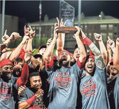  ??  ?? Redbirds players celebrate at AutoZone Park on Saturday after beating the Freno Grizzlies to win the Pacific Coast League championsh­ip. BRAD VEST/THE COMMERCIAL APPEAL