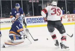  ?? Mary Altaffer / Associated Press ?? Islanders goaltender Thomas Greiss (1) makes the save against Devils right wing Kurtis Gabriel (39) during the first period on Saturday. Greiss made 35 saves for his first shutout of the season.