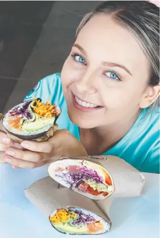  ?? Picture: GLENN HAMPSON ?? Ellie Hastings with the new sushi burritos at Suki at Robina.