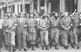  ?? AP ?? REVOLUTION­ARY DAYS Castro, far left, marches with Che Guevara, third from left, and William Morgan, second from right, in March 1960. Morgan was later executed for opposing Castro’s regime.