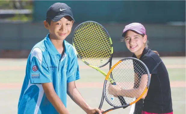  ?? Picture: STEWART McLEAN ?? MELBOURNE-BOUND: Junior tennis players Taichi Sato (Cairns) and Logan Lizzio (Innisfail), both 12, will represent their state at the Red Energy Australian Made Foundation Cup in Melbourne.