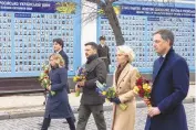  ?? UKRAINIAN PRESIDENTI­AL PRESS OFFICE VIA AP ?? From right, Belgian Prime Minister Alexander De Croo, EU Commission President Ursula von der Leyen, Ukrainian President Volodymyr Zelenskyy, Italy’s Premier Giorgia Meloni and Canadian Prime Minister Justin Trudeau attend a ceremony to lay flowers at the Wall of Remembranc­e, paying tribute to killed Ukrainian soldiers, in Kyiv on Saturday.