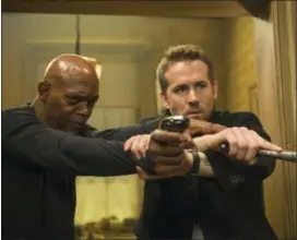  ?? JACK ENGLISH — LIONSGATE VIA AP ?? This image released by Lionsgate shows Samuel L. Jackson, left, and Ryan Reynolds in “The Hitman’s Bodyguard.”