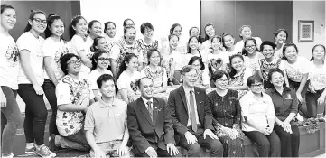  ??  ?? Tok (back row, ninth left) with 29 of the 30 beaming students involved in the making of The Gifts of Life book during its presentati­on ceremony to the National Library and Sabah State Library yesterday.