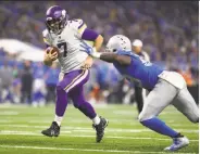  ?? Gregory Shamus / Getty Images ?? Minnesota quarterbac­k Case Keenum shakes off a Detroit defender on a 9-yard touchdown run.