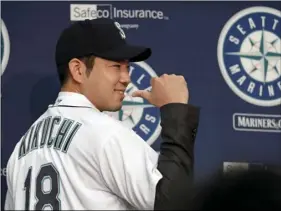  ??  ?? Seattle Mariners pitcher Yusei Kikuchi smiles and shows off his new jersey following a news conference after his signing with the team, on Thursday, in Seattle. AP PHOTO/ELAINE THOMPSO