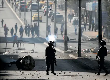  ?? PHOTOS: GETTY IMAGES ?? Israeli security forces intervene during a demonstrat­ion against US President Donald Trump’s recognitio­n of Jerusalem as Israel’s capital, in Bethlehem, West Bank.