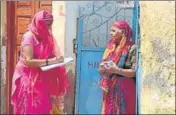  ??  ?? An anganwadi worker delivers medicine to a woman in a containmen­t zone in Gurugram on Thursday.