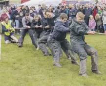  ??  ?? 2 Teamwork is key as young farmers in Wigtown take the strain during a tugof-war contest