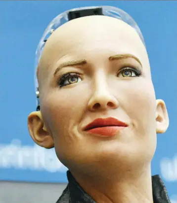  ?? GENYA SAVILOV/AFP/GETTY IMAGES ?? Hong Kong firm Hanson Robotics unveils Sophia the robot in Kiev last week. Kevin Carmichael predicts AI will reshape entire industries and computers will take over thousands of jobs.