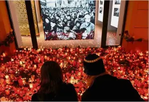  ??  ?? Paying tribute: A couple lighting a candle at a memorial to commemorat­e the 29th anniversar­y of the so-called Velvet Revolution on Nov 17 in Prague. — AFP