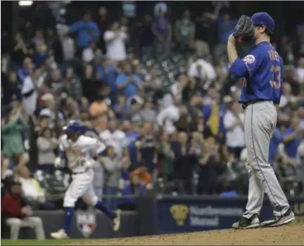  ?? PHOTOS BY MORRY GASH — ASSOCIATED PRESS ?? Mets pitcher Matt Harvey reacts as Brewers’ Eric Sogard rounds the bases after hitting a two-run home run in the sixth inning of Friday night’s game in Milwaukee.