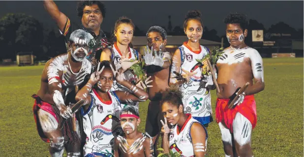  ?? Picture: STEWART McLEAN ?? DEADLY DANCERS: Centrals Trinity Beach Bulldogs girls perform traditiona­l indigenous dancing with the Djabuguy Dancers before their game on Monday night. Pictured are Joe Snider, Wally Brim, Monica Brim, Adrienne Verevis, Wally Brim Jr, Drayden Lawson,...