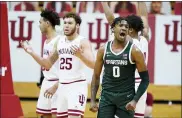  ?? DARRON CUMMINGS — THE ASSOCIATED PRESS ?? Michigan State’s Aaron Henry (0) reacts after hitting a shot and getting fouled during the second half of Saturday’s game against Indiana in Bloomingto­n, Ind. Michigan State won 78-71.