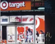  ?? NOAH BERGER — THE ASSOCIATED PRESS ?? People leave a vandalized Target store in Oakland on Saturday during protests decrying the death of George Floyd while in police custody in Minneapoli­s.