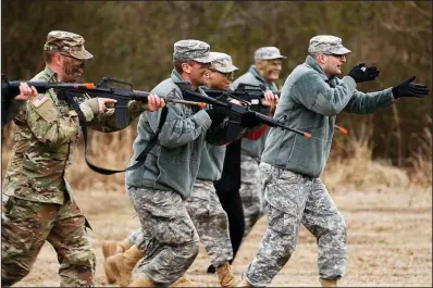  ?? Arkansas Democrat-Gazette/THOMAS METTHE ?? Cadet Alexander Propes (right), a junior at the University of Central Arkansas, leads a flanking maneuver with ROTC cadets during a training exercise on Feb. 1 at UCA in Conway.