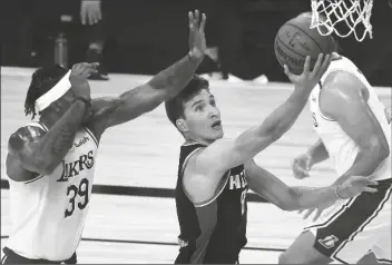  ?? ASSOCIATED PRESS ?? SACRAMENTO KINGS’ BOGDAN BOGDANOVIC (8) goes up for a shot against Los Angeles Lakers’ Dwight Howard (39) during the second quarter of a game on Aug. 13 in Lake Buena Vista, Fla.