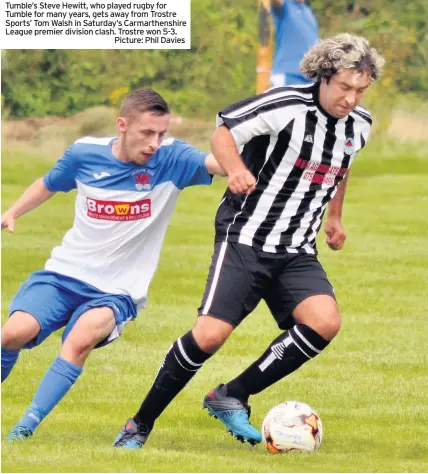  ?? Picture: Phil Davies ?? Tumble’s Steve Hewitt, who played rugby for Tumble for many years, gets away from Trostre Sports’ Tom Walsh in Saturday’s Carmarthen­shire League premier division clash. Trostre won 5-3.