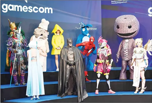  ??  ?? This file photo taken on Aug 22 shows people dressed up as game characters during the opening ceremony of gaming fair ‘Gamescom’ in Cologne, western Germany. (AFP)