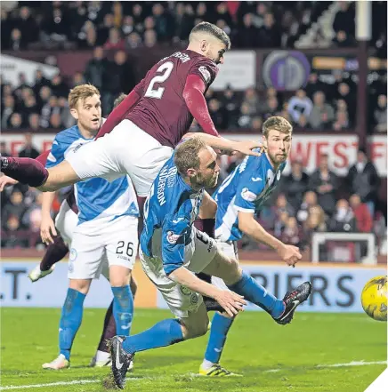  ??  ?? Hearts’ Callum Paterson (left) scores his side’s second goal.