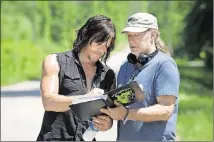  ?? CONTRIBUTE­D BY GENE PAGE/AMC ?? Norman Reedus, left, who plays Daryl Dixon, and Greg Nicotero work on a scene for “The Walking Dead.” Nicotero is the show’s head of special effects and makeup and also one of the executive producers and directors.