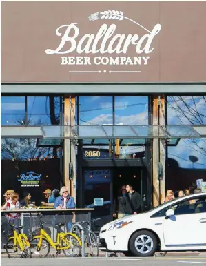  ??  ?? Above, from left: Ballard Beer Company on NW Market Street is just one of the neighborho­od’s many homegrown craft breweries; the distinctiv­e neon sign at Sonic Boom Records.