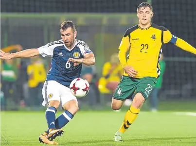  ?? Picture: SNS. ?? James McArthur plays a pass under pressure from Lithuania’s Fiodor Cernych.