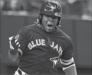  ?? CP PHOTO ?? Toronto Blue Jays’ Vladimir Guerrero Jr. celebrates his walk-off home run to defeat the St. Louis Cardinals 1-0 in the ninth inning of a spring training baseball game Tuesday, March 27, in Montreal.