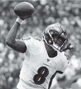  ?? ABBIE PARR Getty Images ?? Ravens quarterbac­k Lamar Jackson is the only quarterbac­k in NFL history to pass for at least 1,600 yards and run for 500 through the first seven games of a season.