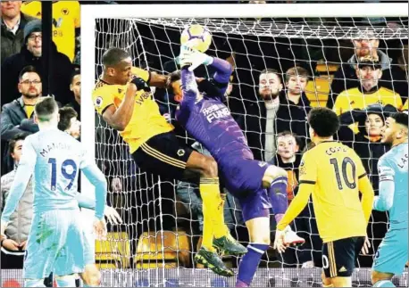  ?? LINDSEY PARNABY/AFP ?? Wolverhamp­ton Wanderers’ French defender Willy Boly (second left) scores their first goal to equalise 1-1 during the Premier League match against Newcastle United at the Molineux stadium in Wolverhamp­ton on Monday.