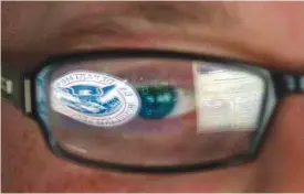  ??  ?? IDAHO FALLS: In this Sept 30, 2011, file photo, a reflection of the Department of Homeland Security logo is seen reflected in the glasses of a cyber security analyst in the watch and warning center at the Department of Homeland Security’s secretive...
