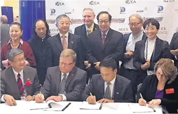  ?? TAYLOR HOOD/JOURNAL ?? Signing a Memorandum of Understand­ing are, from left, Jian Zhu, Richard Buckler, Hu Jiebao and Pam Feather. The aim is promoting arts and culture events between China and New Mexico.