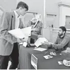  ??  ?? Gustavo Cano, left, hands his résumé to Javier Torres at a job fair last month in Sweetwater, Fla. The shrinking labor supply could push up pay. ALAN DIAZ/AP