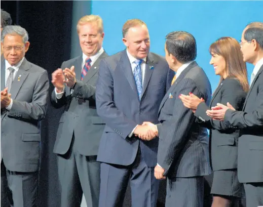  ?? Picture / Nick Reed ?? Then-PM John Key celebrates the ministeria­l signing of the TPP deal in 2016.