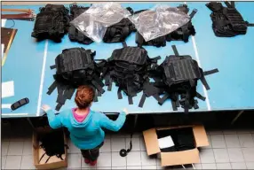  ?? ?? A Ukrainian worker sorts new body armor at a leatherwor­k shop Thursday in Prague. (AP/Petr David Josek)