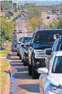  ??  ?? Cars line up Thursday along North Lincoln Boulevard to turn into the Oklahoma County Election Board parking lot. The line backed up to Interstate 44 from the election board at 4201 N. Lincoln Blvd.