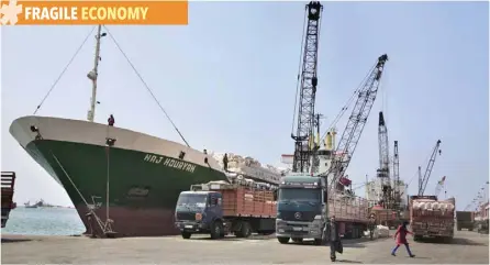  ?? — Reuters ?? Cranes offload hay from a ship onto waiting trucks in the port of the northern city of Tripoli, Lebanon.