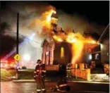  ?? GRAHAM PAINE, METROLAND ?? Burlington firefighte­rs battle a fire at Trinity Baptist Church. Flames broke through the roof and caused a partial collapse of the 120-year-old building.