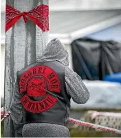  ?? MURRAY WILSON/STUFF ?? A Mongrel Mob member was shot dead in Whanganui. This member is looking across at the window where the recent shooting took place.