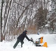  ?? AFP ?? A person clears snow with a snowblower after a winter storm rolled through Western New York, on Tuesday.