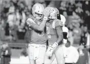  ?? Robert Gauthier Los Angeles Times ?? BRUINS QUARTERBAC­K Josh Rosen embraces Jordan Lasley after his touchdown catch Saturday.