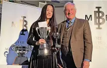  ?? ?? Elizabeth Popova was presented with the Llanelli Star Cup by Sir Gareth Edwards at the annual Brin Isaac Memorial Fund sporting awards at the Stradey Park Hotel in Llanelli in December.