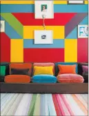  ?? The Rug Company ?? British fashion designer Paul Smith takes a classic stripe and gives it a modern twist with intersecti­ons and overlays in a kaleidosco­pe of colors called Festival. It’s woven in Nepal of hand-knotted Tibetan wool for The Rug Company.