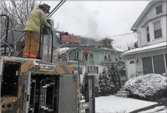  ?? PETE BANNAN – DIGITAL FIRST MEDIA ?? Firefighte­rs battle fire in a home on Melrose Avenue in East Lansdowne. Several residents were chased from the home, but no serious injuries were reported.